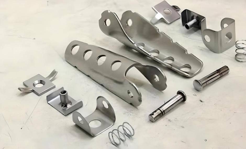 An assortment of parts for foldable cafe-racer passenger footpegs. These generic foldable foot pegs are a good pick for both rider and pillion under all weather. The spring loading keeps the pegs out or tucked in while the bike moves.