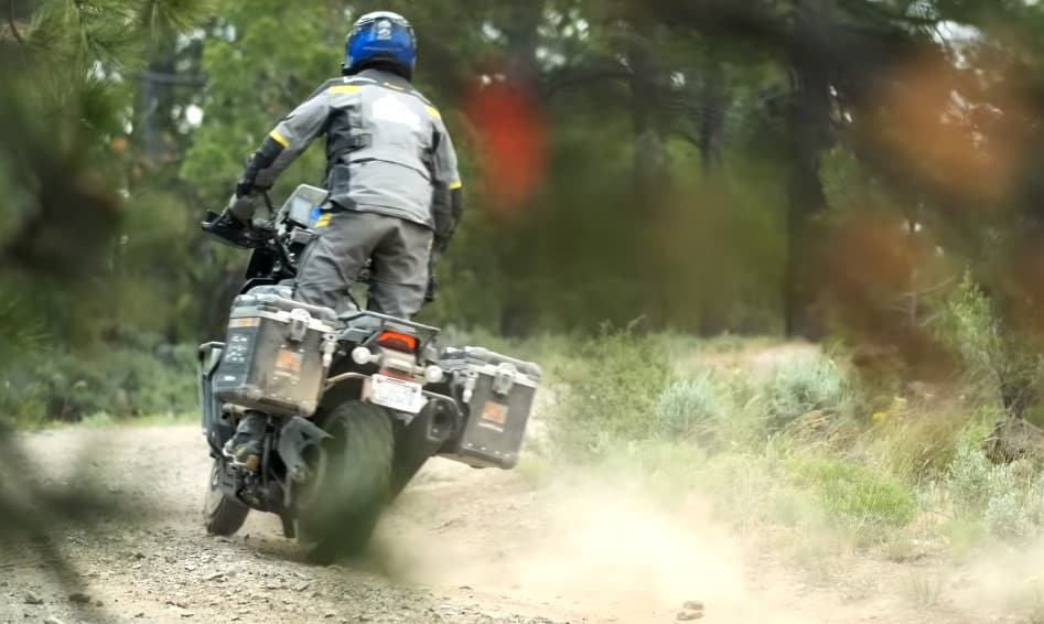 Power sliding a partially loaded R 2150 GS Adventure motorcycle. The side panniers are a necessary baggage to bring at least a weekend worth of food and personal effects.