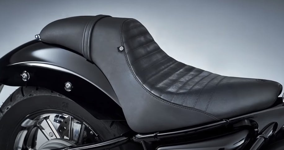 Thick, solo seat with raised rear hump to support the rider’s back under acceleration. The cruiser emphasizes this dominating stance when riding. And this plus cushioned seat is supposed to make up for the stiff rear suspension.