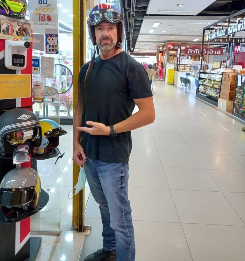 An open-face helmet allows you the freedom to walk around while shopping, as demonstrated here by Todd in Thailand, or easily refuel your motorcycle at the gas station.
