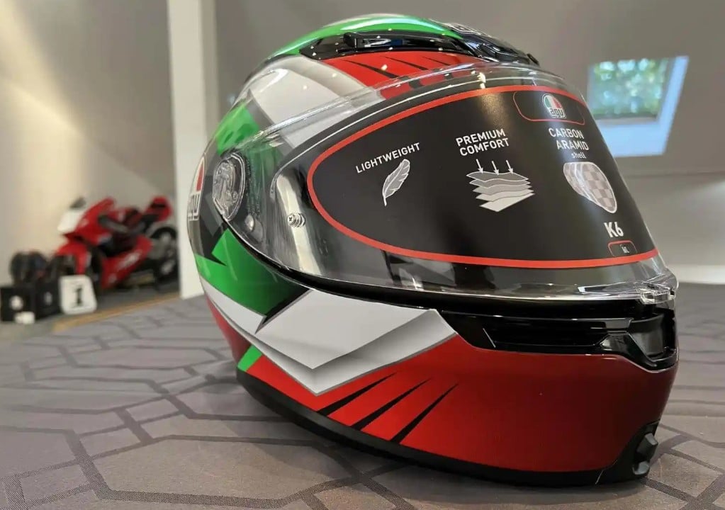 The AGV K6 S Excite Camo/Italy helmet—displayed in my Maryland office—in vibrant red, green, and white, not only adds a touch of style but also offers more than just aesthetics. Its tricolor design, featuring high-visibility colors, contributes to a statistically advantageous profile.