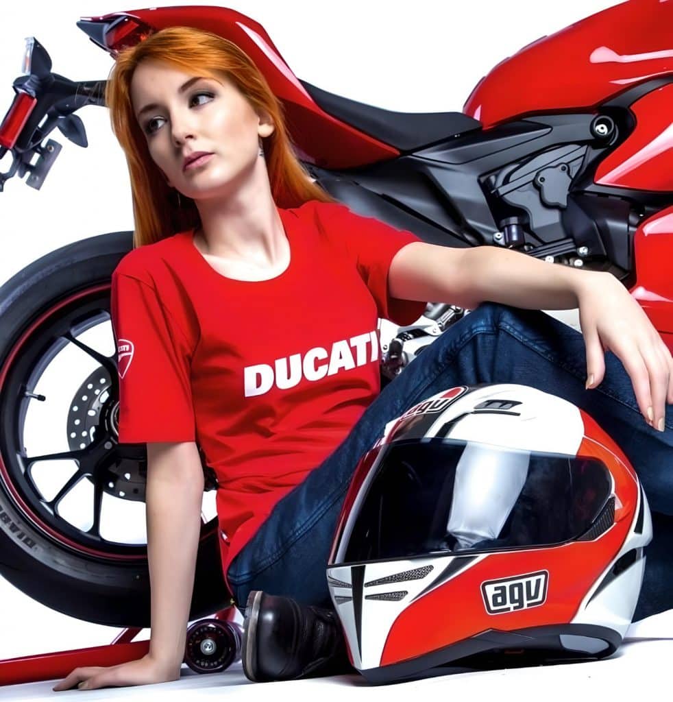 Alice curves her knees during a photoshoot to effectively demonstrate the Kevlar’s flexibility, a key property in its energy-absorbing capabilities that highlights its ability to provide ballistic resistance. The AGV GP-Tech Marco Simoncelli helmet rests on the floor beside her, while the Ducati motorcycle looms in the background.