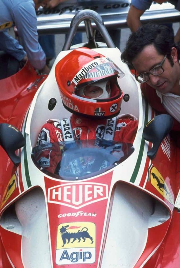 In 1976, Scuderia Ferrari driver Niki Lauda from Austria shares a moment with Mauro Forghiere before a race.